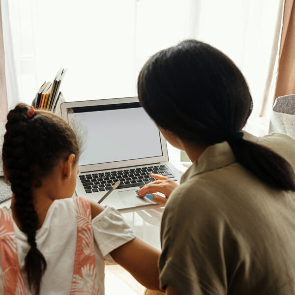 A mother helps her daughter with her homework