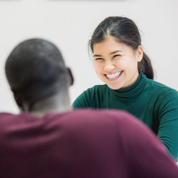 Young student smiling to her teacher